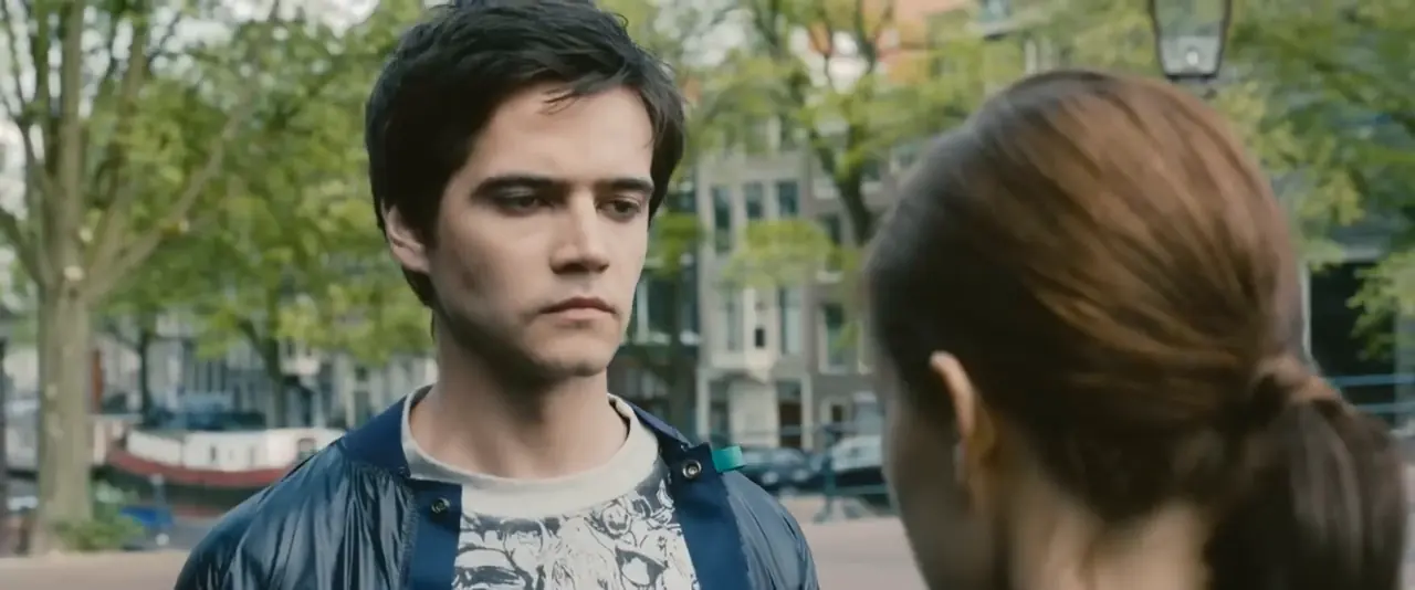 A frame with Tom facing the camera on the left and Celia seen from behind on the right. A yellow box marks Tom's face; the red 9:16 crop and the green 4:5 crop are centred on him, not on the middle of the image.